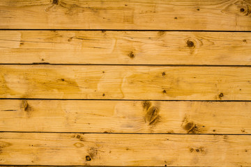 Light brown wooden planks, wall, table, ceiling or floor surface.