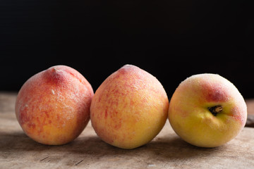 Three peaches on wooden, tropical fruit