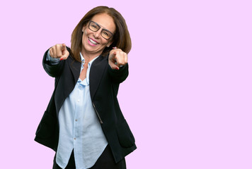 Middle age business woman pointing to the front with finger