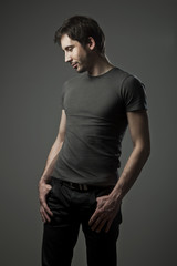 Fototapeta na wymiar Attractive young man in gray t-shirt