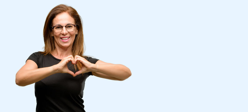 Middle Age Woman Wearing Black Shirt And Glasses Happy Showing Love With Hands In Heart Shape Expressing Healthy And Marriage Symbol Isolated Blue Background