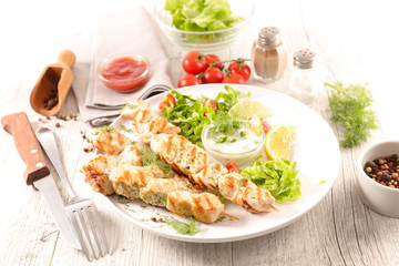 fried chicken skewer and salad