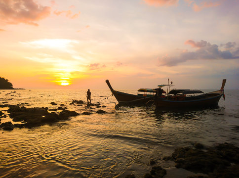 Fisherman with Sunset and Boat at Koh Bulone island, Panka Yai beach, Satun Thailand