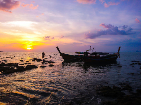 Fisherman with Sunset and Boat at Koh Bulone island, Panka Yai beach, Satun Thailand