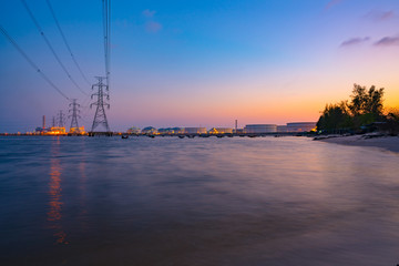 Fototapeta premium power plant light riverfront reflection at twilight- industrial landscape background