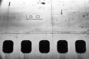 Dystopic image of the cabin windows on an old abandoned jet plane / aircraft. Concept of fear of flying or flying / aero phobia.