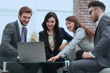 Beautiful business people are using a laptop during the conferen