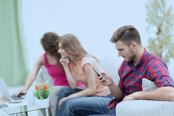 group of young people resting on the couch in the living room.