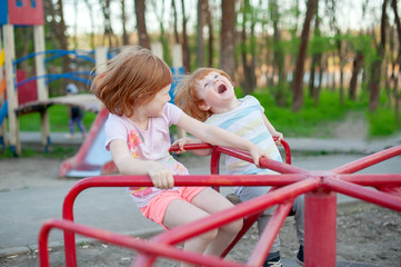 Fototapeta na wymiar Children ride on the carousel in the park