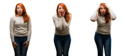 Young Beautiful redhead woman happy and surprised cheering expressing wow gesture