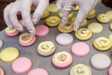 cooking, confectionery and baking concept - macarons on table
