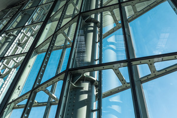 The glass architecture in city against a sky