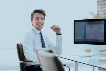 employee sitting in front of a computer screen