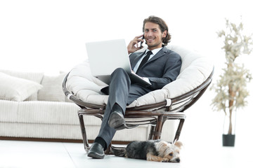 business man talking on a smartphone sitting in the living room