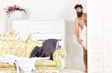 Man, lover in white interior caught naked. Man with beard and mustache hiding behind folding...