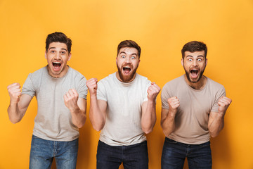 Three young happy men celebrating success together
