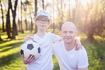 Happy father and son portrait in park