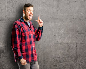 Young handsome man pointing away side with finger