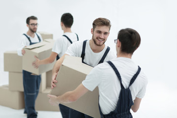 Portrait of movers holding box smiling isolated on white backgro