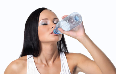 Sporting girl drinking water during exercise