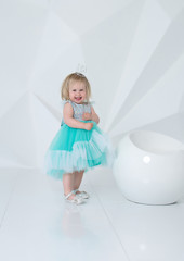  A LITTLE GIRL IN A BLUE DRESS SMILES