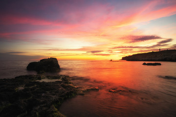 Beautiful summer landscape with sunset, colorful sky and sea coast. Composition of nature