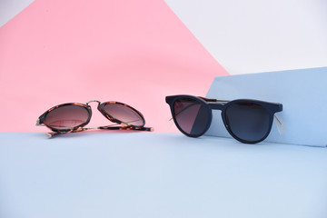 sunglasses / eyewear on pastel color paper background 
