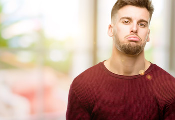 Fototapeta premium Handsome young man with sleepy expression, being overworked and tired