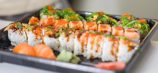 Delicious sushi, japanese food with raw fish, avocado and rice