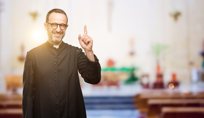 Priest religion man raising finger, the number one at church
