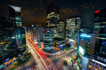 Night scene of light trails traffic speeds through an intersection in Gangnam center business...