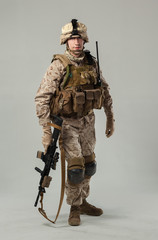 Soldier in camouflage holding rifle