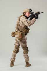 Soldier in camouflage holding rifle