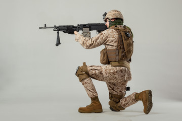 Soldier in camouflage holding rifle