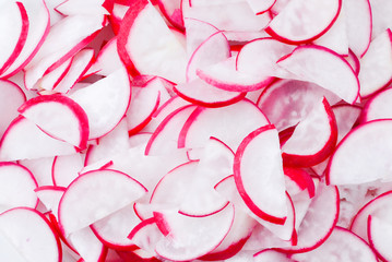 Natural background with fresh radishes slices