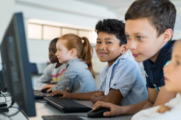 Children using computer in school - Powered by Adobe