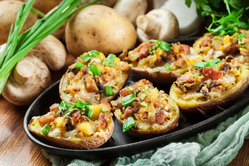Baked potatoes in jacket stuffed with bacon, mushrooms and cheese. Dish served in baking dish..Baked potatoes stuffed with bacon, mushrooms and cheese