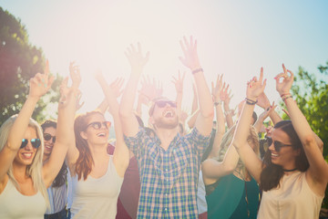 Group of people dancing and having a good time at the outdoor party/music festival