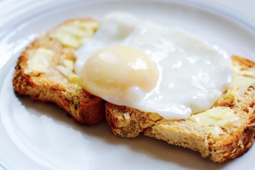 The perfect poached egg on seeded buttered brown toast 