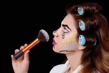 Model with pop art makeup against black background.