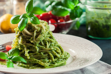 Pasta spaghetti with homemade basil pesto sauce on white plate