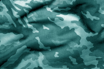 Military uniform pattern with blur effect in cyan tone.