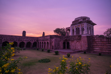 Mandu India, afghan ruins of islam kingdom, mosque monument and muslim tomb. Colorful sky at sunrise, Ashrafi Mahal.