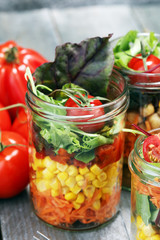 Homemade salad in glass jar with vegetables. Healthy food, diet, detox and clean eating
