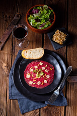 Carpaccio of beef with pine nuts, colorful pepper and Parmesan cheese