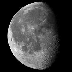 Close up of the entire Moon in its waning gibbous phase, with detailed craters on the right near the shadow, taken with large newtonian telescope and all in a black framed background.
