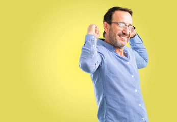 Fototapeta premium Handsome middle age man showing biceps expressing strength and gym concept, healthy life its good