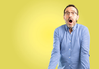 Fototapeta premium Handsome middle age man happy and surprised cheering expressing wow gesture