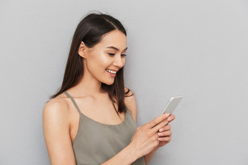 Portrait of a smiling asian woman using mobile phone