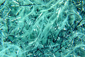 abstract background of shiny blue and white tinsel and glitter